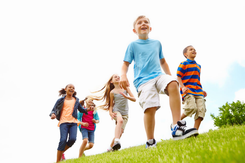 Happy kids, playing or friends running in park