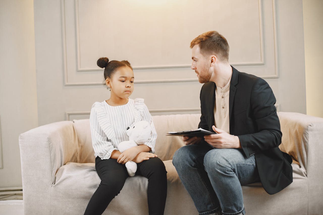 A young girl and a counselor having a therapy session