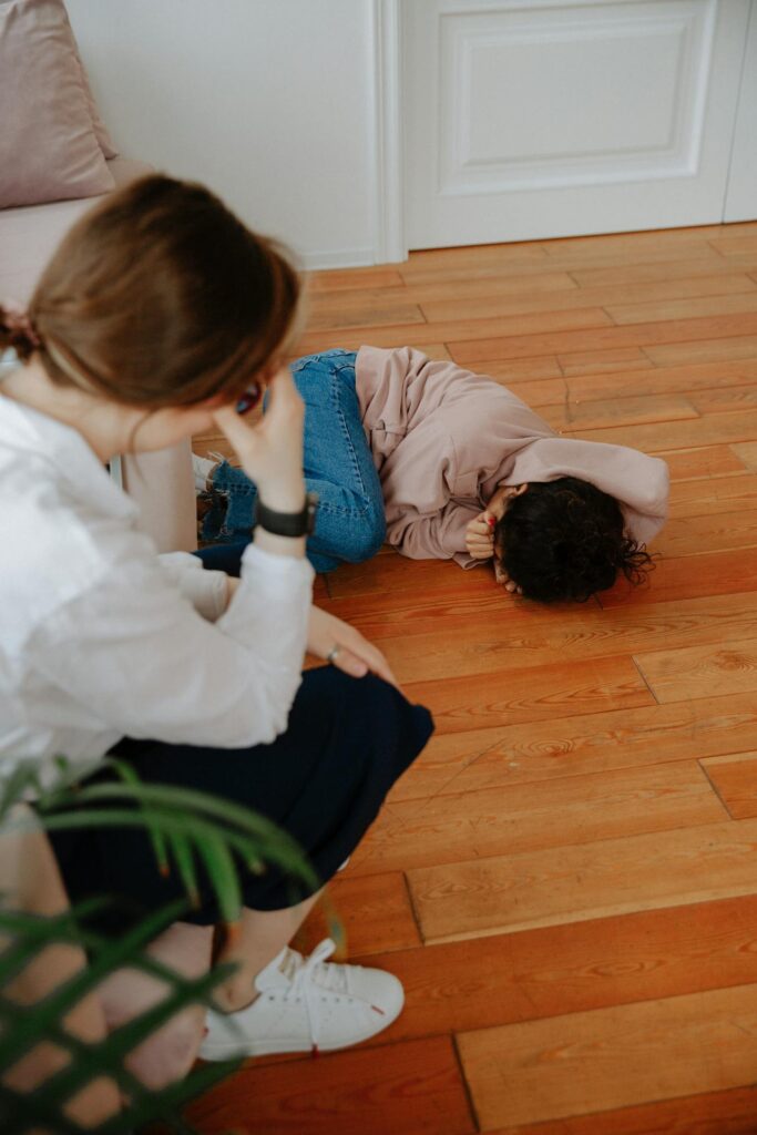A young woman in distress during a counseling session with her therapist indoors.