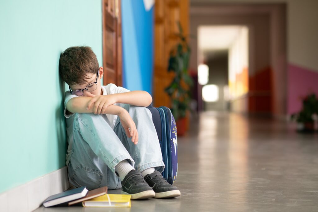 little boy sitting on floor alone